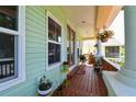 Inviting front porch with plants, seating, and views of the neighborhood at 395 Ulelah Ave, Palm Harbor, FL 34683