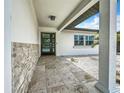 Modern entryway with stone accent wall and updated flooring at 240 N Julia Cir, St Pete Beach, FL 33706