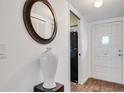 Entryway with a large mirror, white door, and a tall white vase at 2284 Spanish Dr # 40, Clearwater, FL 33763