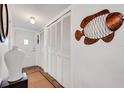 Bright entryway with white wood closet doors and decorative wall art at 2284 Spanish Dr # 40, Clearwater, FL 33763