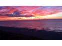 Panoramic ocean view at sunrise featuring vibrant pink and purple sky over the horizon at 1380 Gulf Blvd # 307, Clearwater Beach, FL 33767
