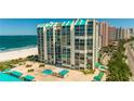 Aerial view of beachfront building with pool and ocean at 1380 Gulf Blvd # 307, Clearwater Beach, FL 33767
