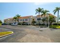 Condo building with parking and tropical landscaping at 6131 Bahia Del Mar Blvd # 236, St Petersburg, FL 33715