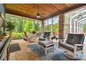 Relaxing screened porch with wood ceiling, comfortable seating, and outdoor views at 3204 Polo Pl, Plant City, FL 33566