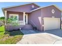 Purple house with a two-car garage and manicured lawn at 3425 Overlook Ne Dr, St Petersburg, FL 33703