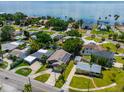 Aerial view of waterfront homes with lush landscaping and solar panels at 3425 Overlook Ne Dr, St Petersburg, FL 33703