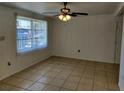 Spacious living area with tile floors and a ceiling fan at 6639 Sandra Dr, Port Richey, FL 34668