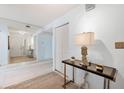 Bright and airy entryway with tiled floors, a console table, and large mirror at 138 1St E St # 106, Tierra Verde, FL 33715