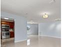 Open living room with light walls and tile floors at 5660 80Th N St # A208, St Petersburg, FL 33709