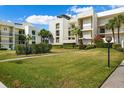Modern condo building with lush landscaping and convenient walkways at 50 Coe Rd # 331, Belleair, FL 33756