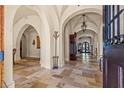 Grand entry with high ceilings, arched doorways and elegant tile flooring at 7725 Still Lakes Dr, Odessa, FL 33556