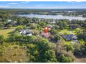 Luxury estate home situated on waterfront property with lush landscaping at 7725 Still Lakes Dr, Odessa, FL 33556