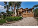 Mediterranean style home with palm trees and large driveway at 806 Columbus Dr, Tierra Verde, FL 33715