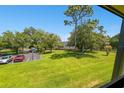 View of parking lot and green space from a condo at 36750 Us Highway 19 N # 22208, Palm Harbor, FL 34684
