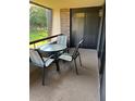 Small balcony with table and chairs overlooking a green space at 36750 Us Highway 19 N # 22208, Palm Harbor, FL 34684