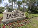 Tampa Bay Golf & Country Club entrance with landscaping and signage at 10727 Duck Hook Ct, San Antonio, FL 33576