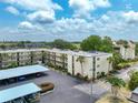 Aerial view of condo building, parking and surrounding area at 11485 Oakhurst Rd # 107, Largo, FL 33774