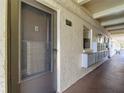 Exterior view of condo building entrance with mailboxes and unit number 107 at 11485 Oakhurst Rd # 107, Largo, FL 33774