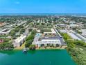 Aerial view of waterfront condo community with pool and parking at 11485 Oakhurst Rd # 107, Largo, FL 33774
