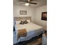 Comfortable bedroom featuring a bed with a padded headboard, soft lighting, and warm decor at 5347 81St N Ln # 22, St Petersburg, FL 33709