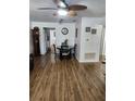 Bright dining area with wood-look floors, a modern chandelier, seating for four, and access to the kitchen at 5347 81St N Ln # 22, St Petersburg, FL 33709