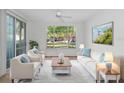 Living Room with light beige sofas and large window at 10590 Windsor Lake Ct # 0, Tampa, FL 33626