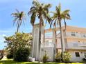 Condo building exterior with palm trees and building number L-948 at 948 Virginia St # 205, Dunedin, FL 34698