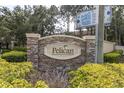 Stone and brick Pelican Pointe entrance sign with landscaping at 6226 Anhinga Pl, Tampa, FL 33615