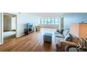 Hardwood floors, light walls, and a couch define this living room at 5130 Brittany S Dr # 202, St Petersburg, FL 33715