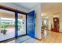 Bright entryway with blue door, tiled floor, and glimpses of living spaces at 4981 61St S Ave, St Petersburg, FL 33715