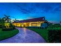 Attractive home at night with brick driveway and landscaping at 4981 61St S Ave, St Petersburg, FL 33715