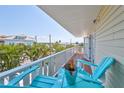 Balcony view featuring a waterfront view, seating, and celebratory champagne at 13004 Boca Ciega Ave, Madeira Beach, FL 33708