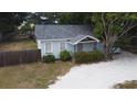 Quaint light blue house with mature landscaping at 14255 Walsingham Rd, Largo, FL 33774