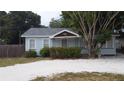 Charming light blue house with a well-maintained yard at 14255 Walsingham Rd, Largo, FL 33774