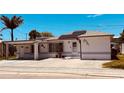 Single story home with solar panels and paved driveway at 14845 N Bayshore Dr, Madeira Beach, FL 33708