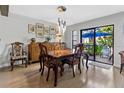 Dining room with ornate wood furniture and an exterior view and sliding door at 240 Windward Psge # 602, Clearwater Beach, FL 33767