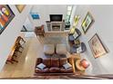 View of the living room boasting a fireplace, TV, hardwood floors, and plenty of seating at 240 Windward Psge # 602, Clearwater Beach, FL 33767