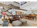 Cozy living room boasts hardwood floors, a staircase, and an open floor plan to the kitchen and dining room at 240 Windward Psge # 602, Clearwater Beach, FL 33767