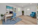 Inviting home office with bright natural light, stylish decor, and comfortable blue accents at 7414 Van Dyke Rd, Odessa, FL 33556