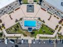 Aerial view of the community pool and landscaping at this condo complex at 1 Key Capri # 104E, Treasure Island, FL 33706