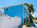 Side view of a light blue house with a white fence at 1826 58Th S St, Gulfport, FL 33707