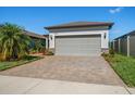 Attached two-car garage with paver driveway at 20591 Monza Loop, Land O Lakes, FL 34638