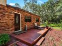 Brick home with side patio and lush landscaping at 1811 Martin Rd, Dover, FL 33527