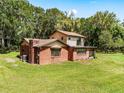Rear view of two-story brick home, showcasing its size and layout at 1811 Martin Rd, Dover, FL 33527