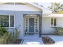 Front entrance of a light blue ranch style home at 5523 Carlton Rd, New Port Richey, FL 34652