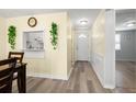 Hallway view with light flooring, pass-through kitchen window and access to other rooms at 4239 Tamargo Dr, New Port Richey, FL 34652