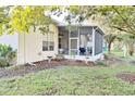 Backyard with screened patio and partially visible grilling area at 542 Farragut Ct, Spring Hill, FL 34609