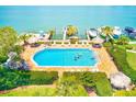 Relaxing resort-style pool with plenty of lounge chairs at 736 Island Way # 404, Clearwater Beach, FL 33767