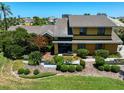 Two-story house with landscaping and a yellow exterior at 309 Belle Isle Ave, Belleair Beach, FL 33786