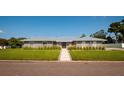 Charming single-story home featuring a metal roof, well-manicured lawn, and inviting walkway at 3931 38Th S Way, St Petersburg, FL 33711
